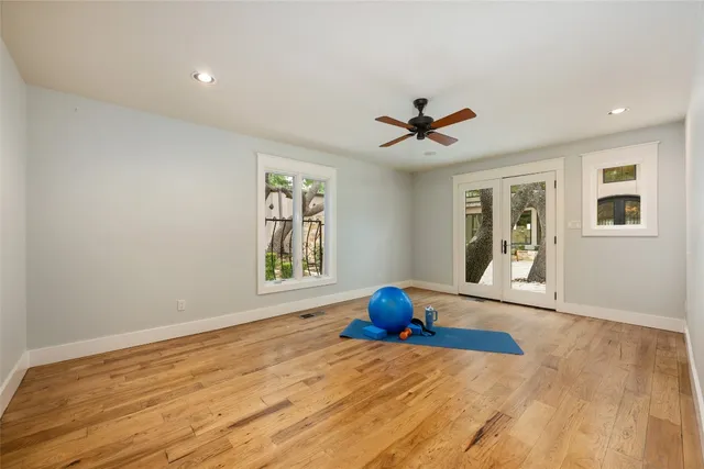 a view of a livingroom with wooden floor and a ceiling fan