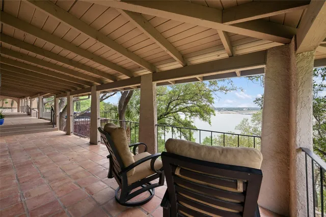 a view of a porch with furniture and a yard