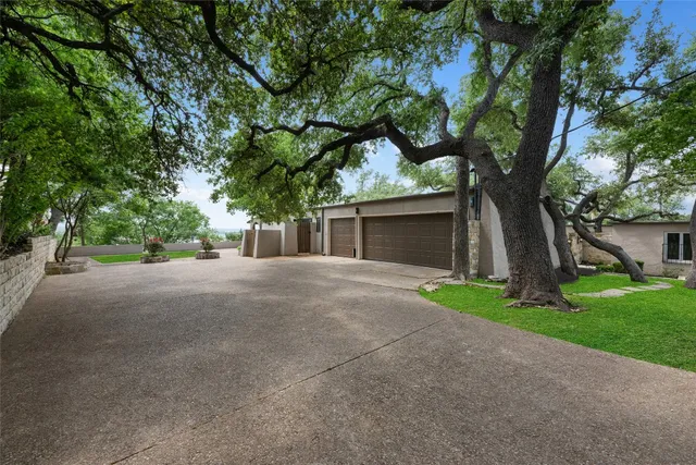 a view of a house with a tree and a yard