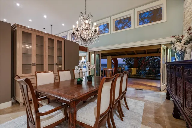 a view of a dining room with furniture and chandelier
