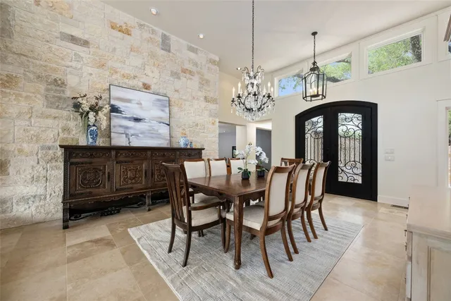 a view of a dining room with furniture and chandelier