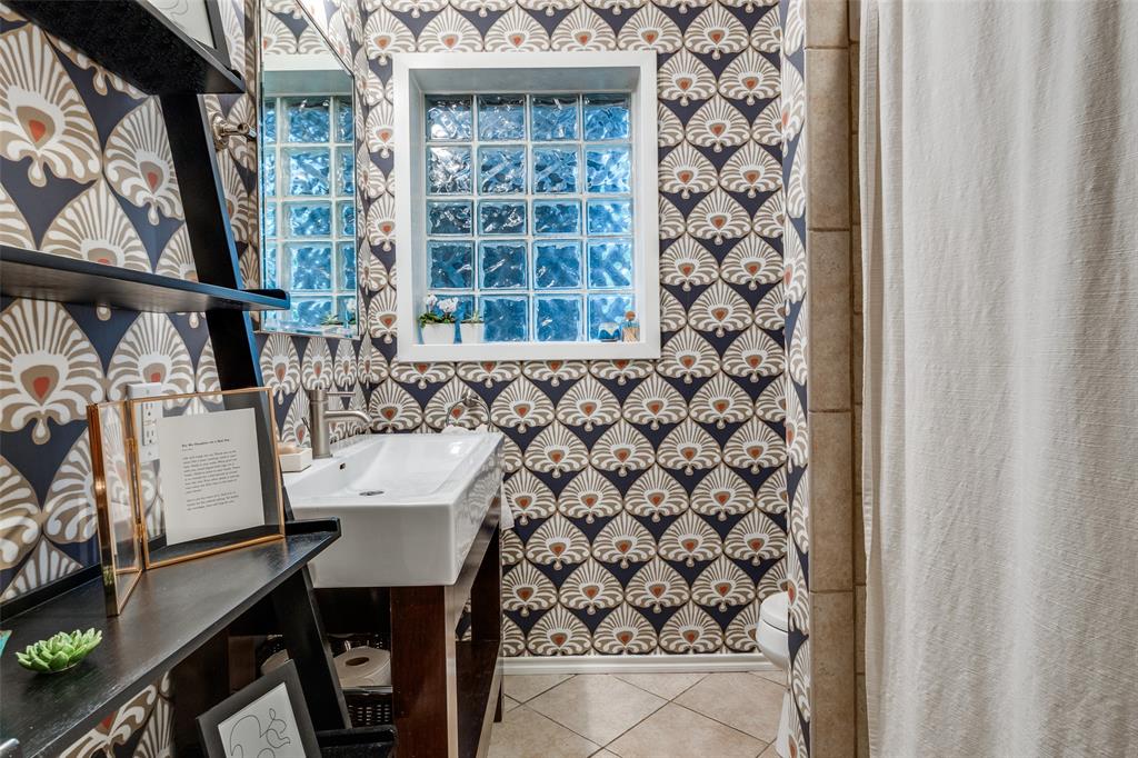 4159 Clover Lane Dallas, TX 75220 - Photo 14 of 25 Bathroom with wallpapered walls, tile patterned floors, vanity, a shower with curtain, and baseboards