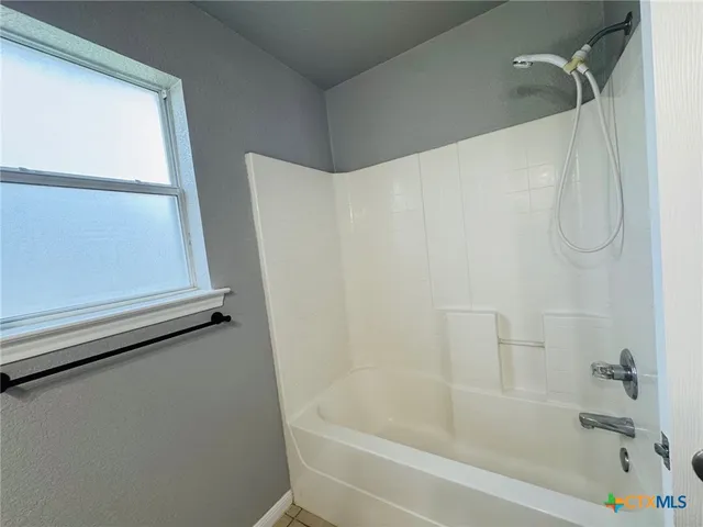 a bathroom with a bath tub and a shower