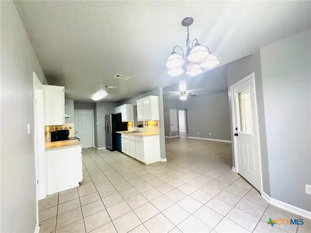 a view of a kitchen with granite countertop cabinets and stainless steel appliances