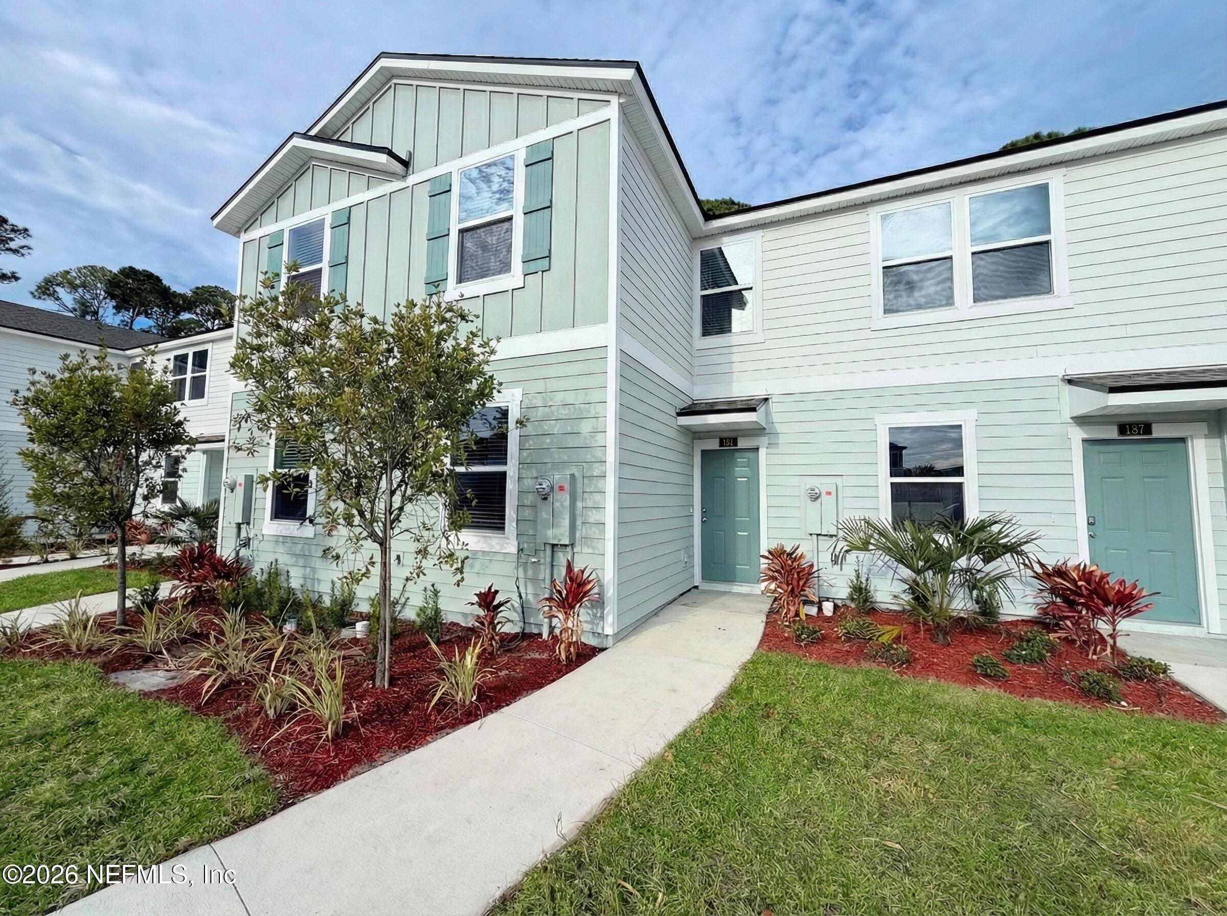 a view of a house with yard and sitting area