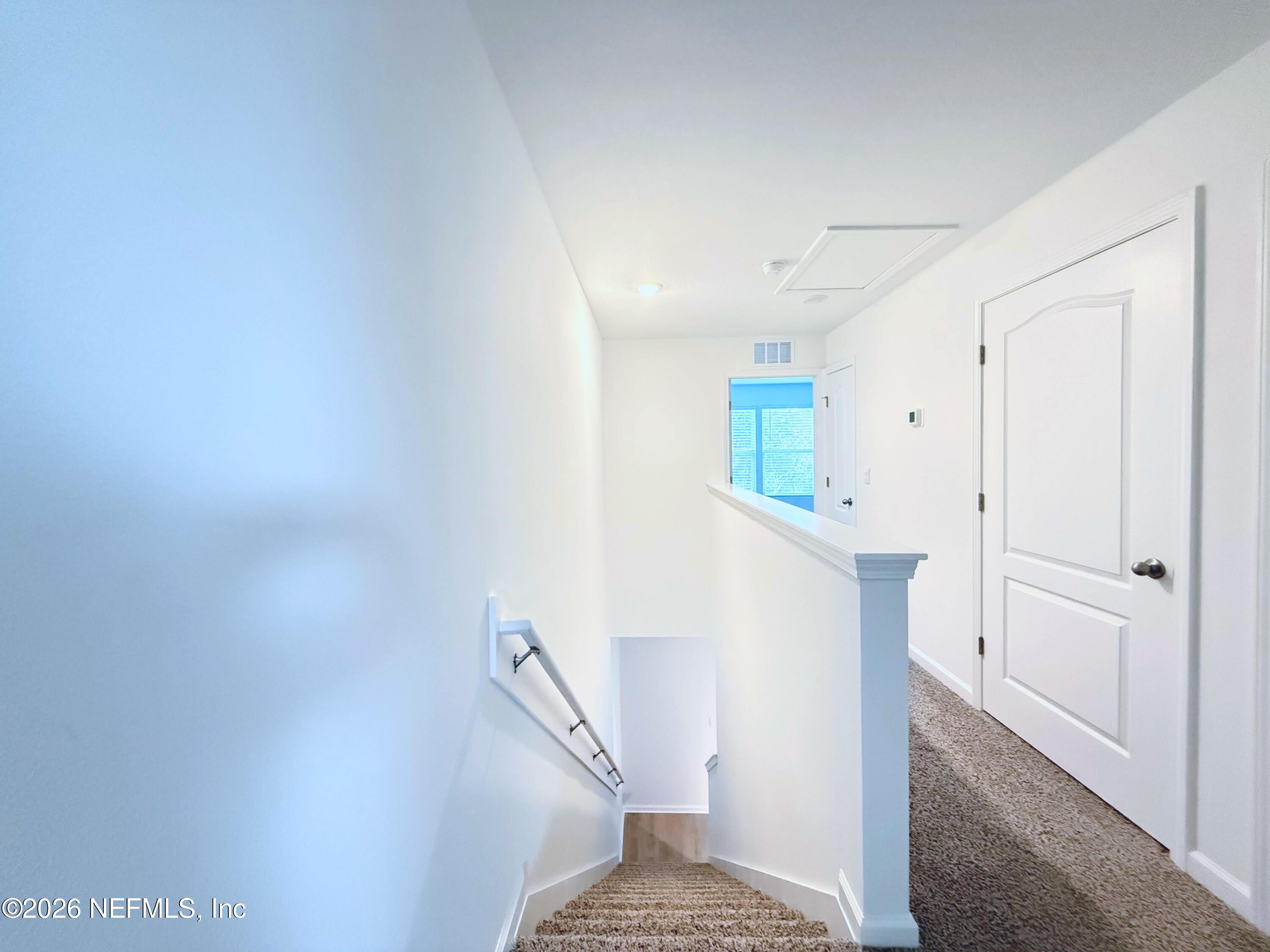 135 Palmetto Rdg Road St. Augustine, FL 32095 - Photo 19 of 19 a view of a hallway with wooden floor and staircase