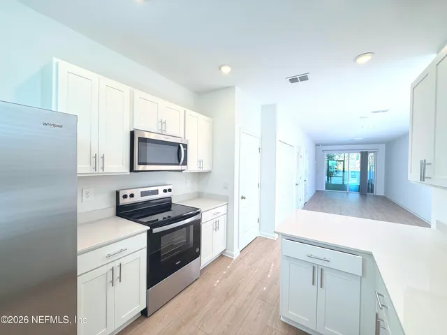 a kitchen with a sink stove and microwave