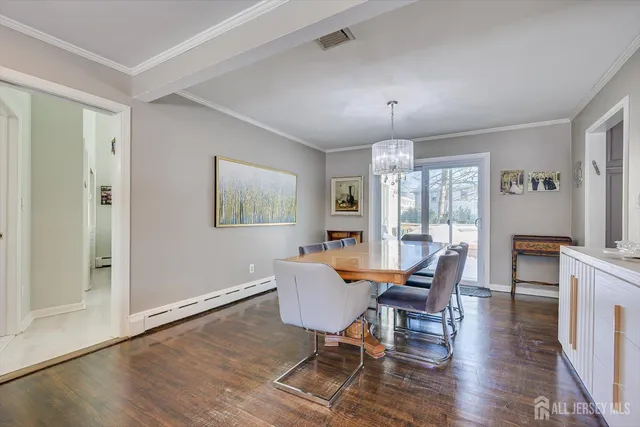 a view of a dining room with furniture wooden floor and chandelier