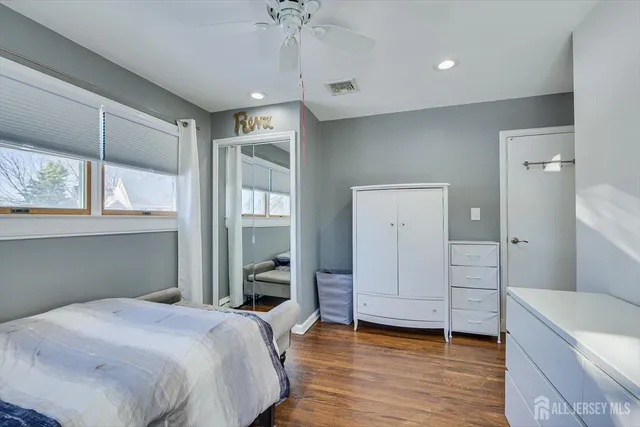 a bedroom with a bed and a chair