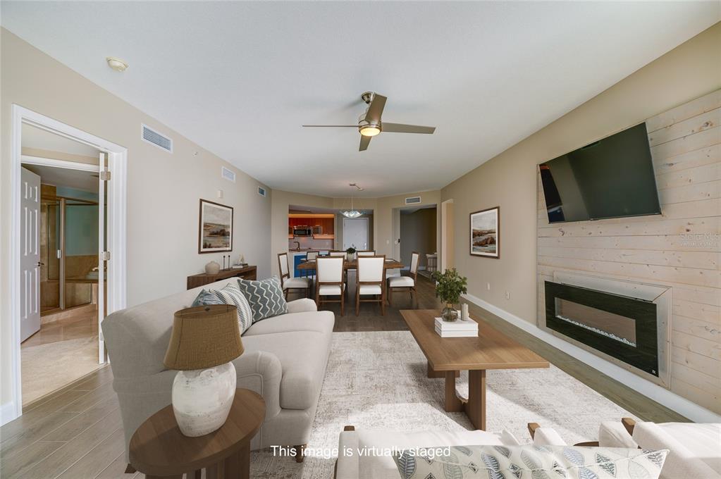 231 Riverside Drive, Unit 1703 Holly Hill, FL 32117 - Photo 11 of 41 a living room with furniture fireplace and a flat screen tv