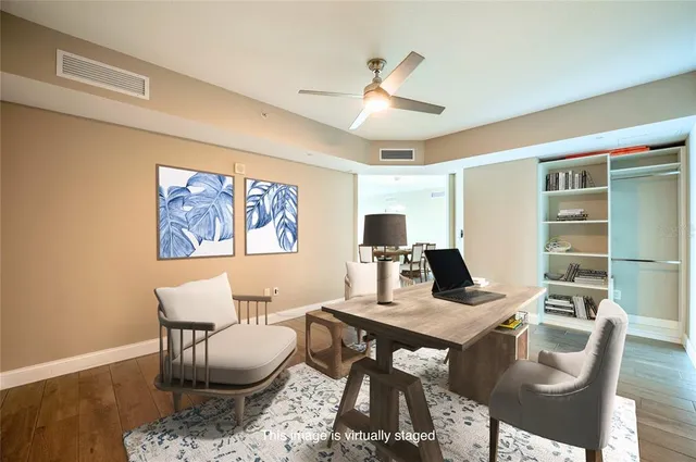 a work room with furniture and view of kitchen