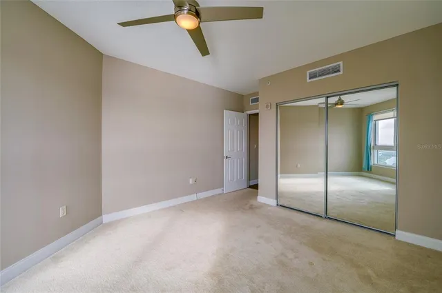 an empty room with a glass door and shower