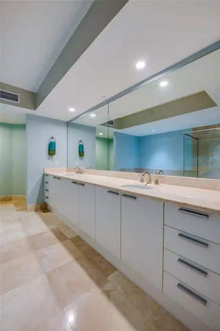 a large white kitchen with a sink