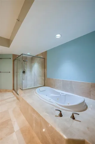 a bathroom with a tub and shower