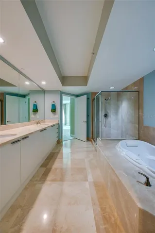 a large spacious bathroom with a large mirror vanity and shower