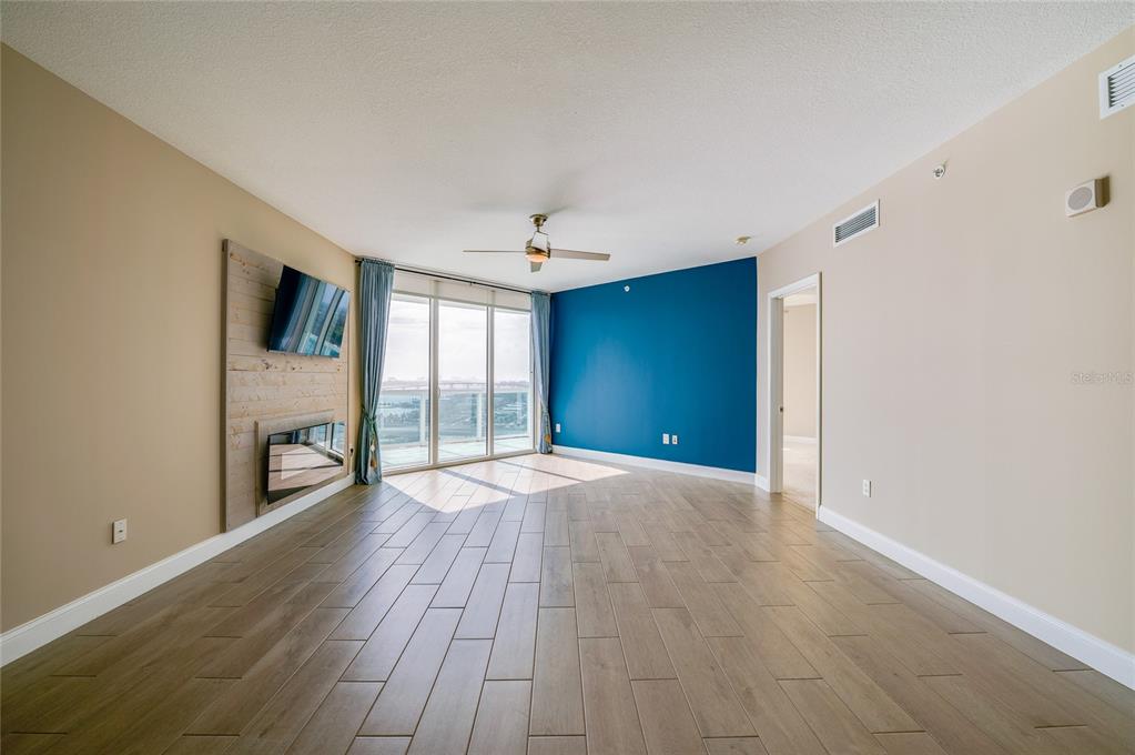 231 Riverside Drive, Unit 1703 Holly Hill, FL 32117 - Photo 7 of 41 a view of an empty room with wooden floor and a window