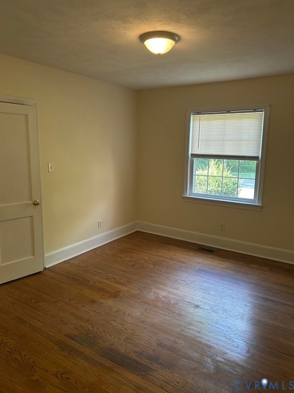 311 5th Street Blackstone, VA 23824 - Photo 4 of 6 an empty room with wooden floor and windows