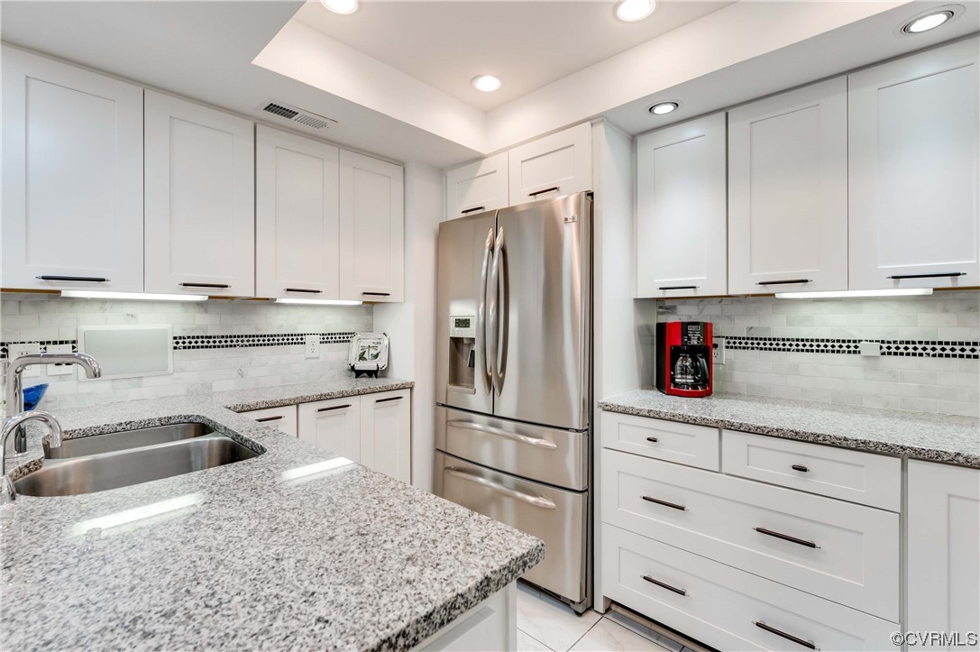 2956 Hathaway Road, Unit U306 Richmond, VA 23225 - Photo 11 of 36 a kitchen with granite countertop a refrigerator sink and cabinets