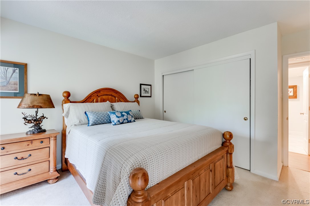 2956 Hathaway Road, Unit U306 Richmond, VA 23225 - Photo 28 of 36 a bedroom with a bed and a chandelier