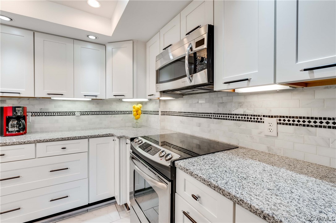 2956 Hathaway Road, Unit U306 Richmond, VA 23225 - Photo 10 of 36 a kitchen with granite countertop a sink stainless steel appliances and cabinets