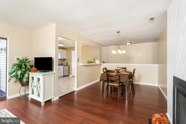 a dining room with furniture and wooden floor