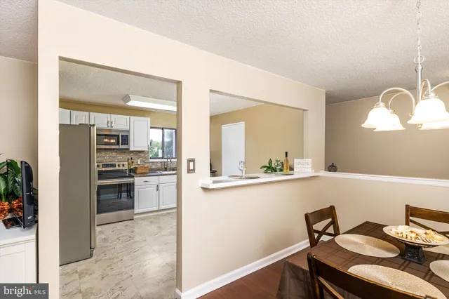 a kitchen with a sink cabinets and dining table