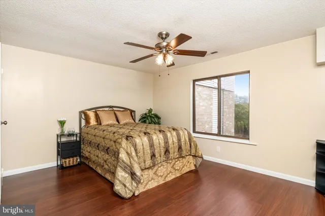 a spacious bedroom with a bed and window