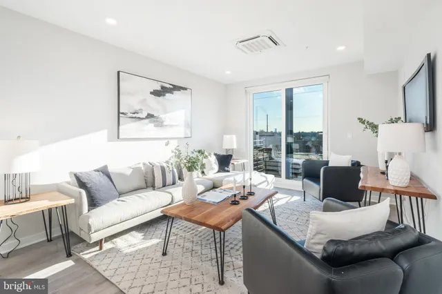 a living room with furniture and a large window