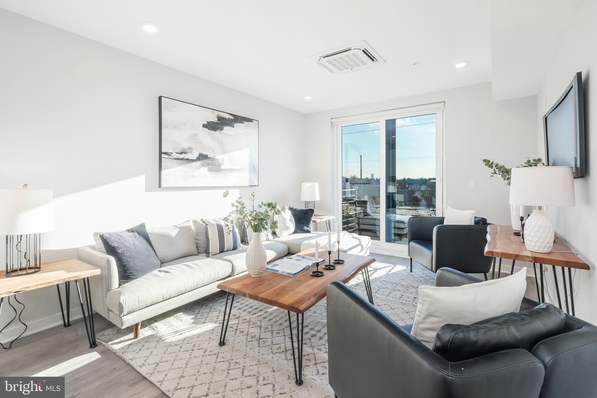 a living room with furniture and a large window