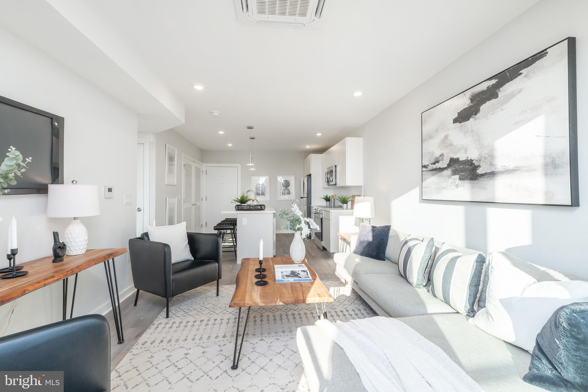 3449 Scotts Lane, Unit B308 Philadelphia, PA 19129 - Photo 5 of 16 a living room with furniture and a large window
