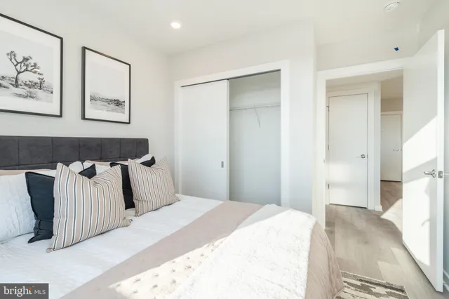 a bedroom with a bed and wall painting