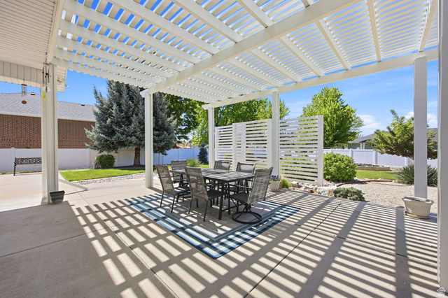 776 Flint Street Layton, UT 84041 - Photo 24 of 41 Spacious concrete patio featuring a white slatted pergola, providing shade and outdoor living space