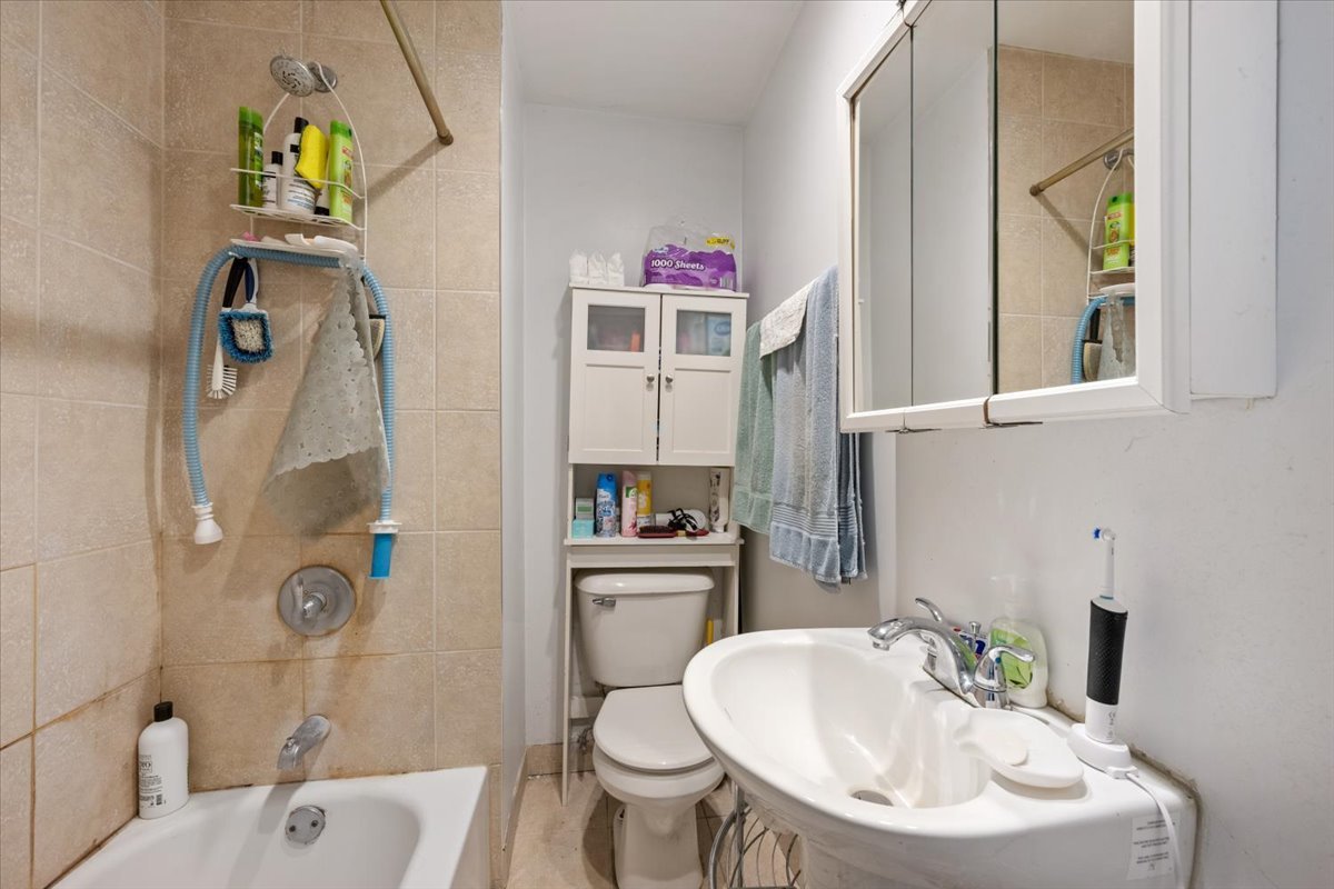934 West 35th Place Chicago, IL 60609 - Photo 17 of 24 a bathroom with a sink toilet and shower
