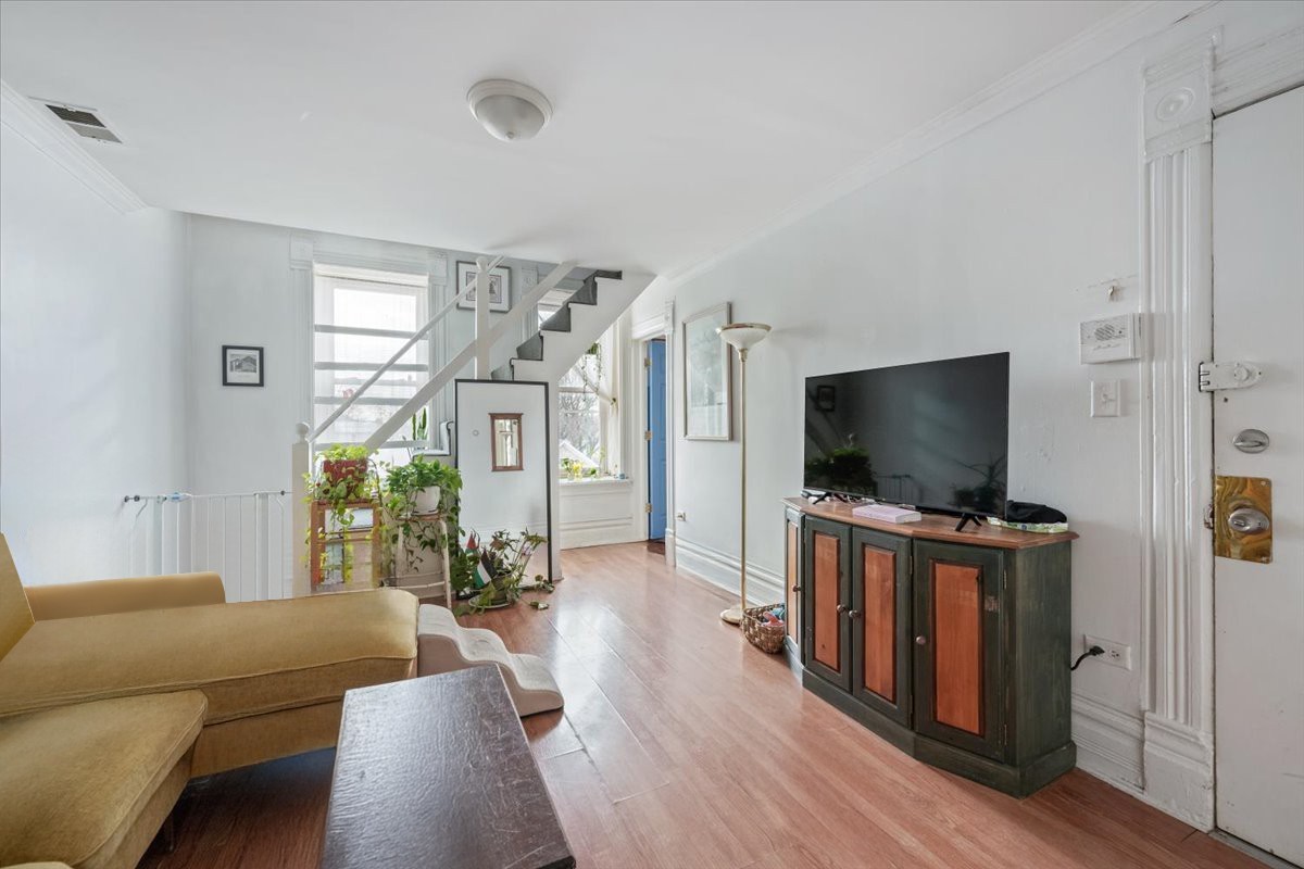 934 West 35th Place Chicago, IL 60609 - Photo 4 of 24 a living room with furniture and a flat screen tv