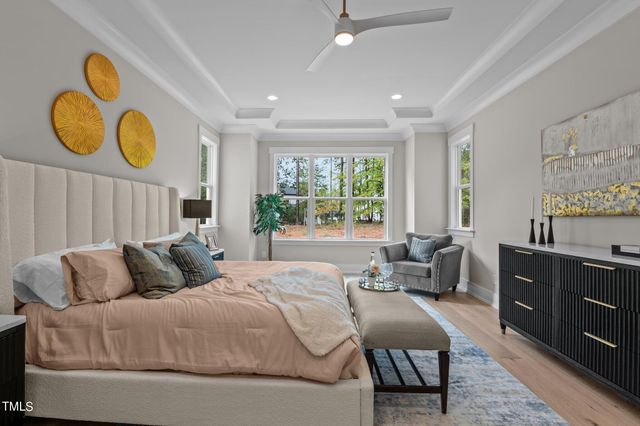 a bedroom with a bed and dresser with mirror