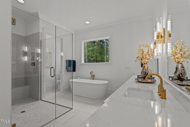 a bathroom with a tub sink and mirror
