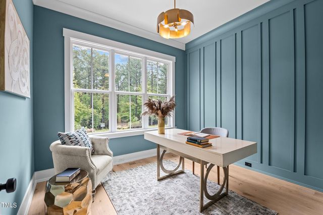 a work room with furniture and a window