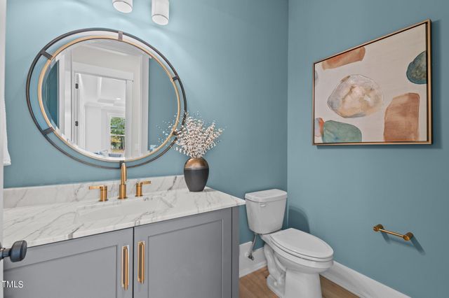 a bathroom with a toilet a sink and a mirror