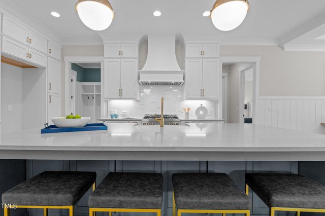 a kitchen with stainless steel appliances granite countertop a sink and a white cabinets