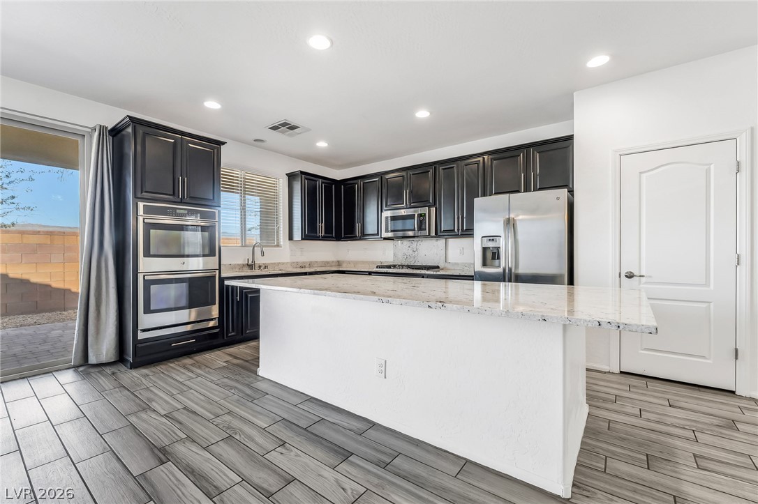 6245 Andover Wood Road Las Vegas, NV 89113 - Photo 8 of 37 An inviting kitchen features a large island and ample cabinet storage for all culinary needs.