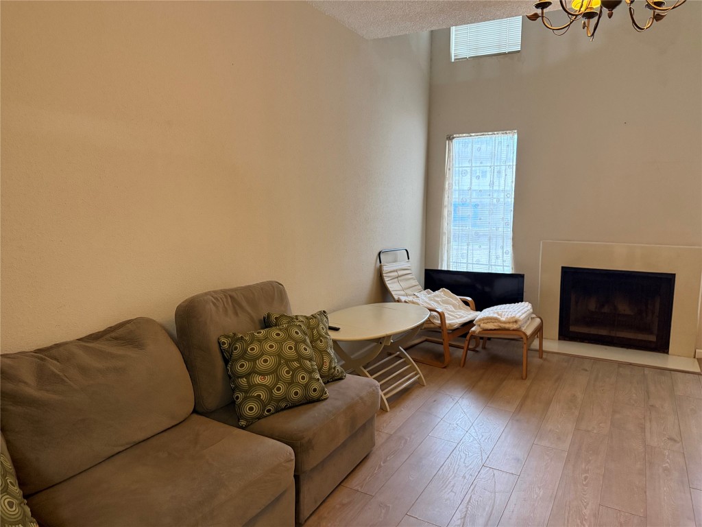 7575 Cambridge Street, Unit 2704 Houston, TX 77054 - Photo 2 of 28 a living room with furniture and a wooden floor