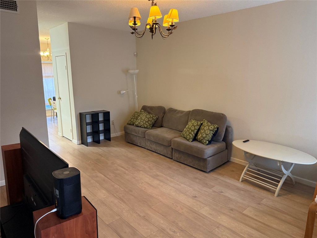 7575 Cambridge Street, Unit 2704 Houston, TX 77054 - Photo 4 of 28 a living room with furniture and a flat screen tv