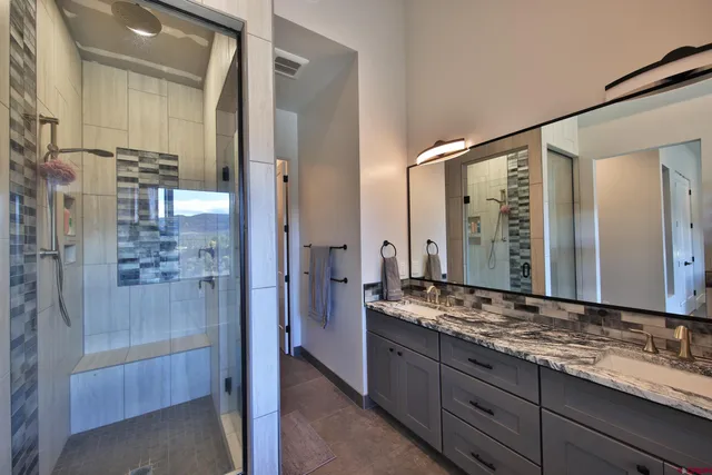 a bathroom with a granite countertop sink mirror and double