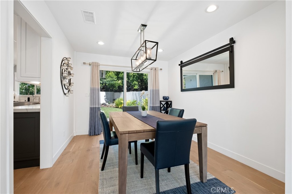 2744 Gannet Drive Costa Mesa, CA 92626 - Photo 19 of 39 a view of a dining room with furniture window and wooden floor