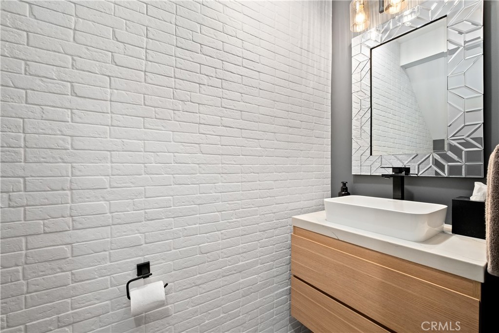 2744 Gannet Drive Costa Mesa, CA 92626 - Photo 21 of 39 a bathroom with a sink a toilet and a mirror