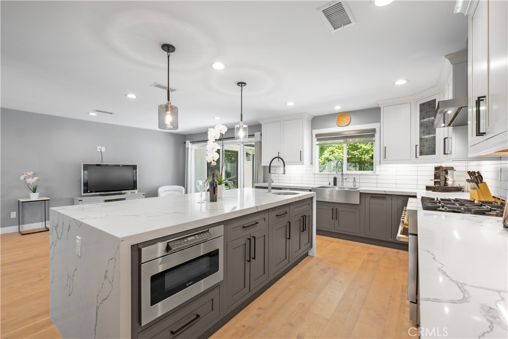 2744 Gannet Drive Costa Mesa, CA 92626 - Photo 5 of 39 a kitchen with a stove a sink a microwave and a refrigerator