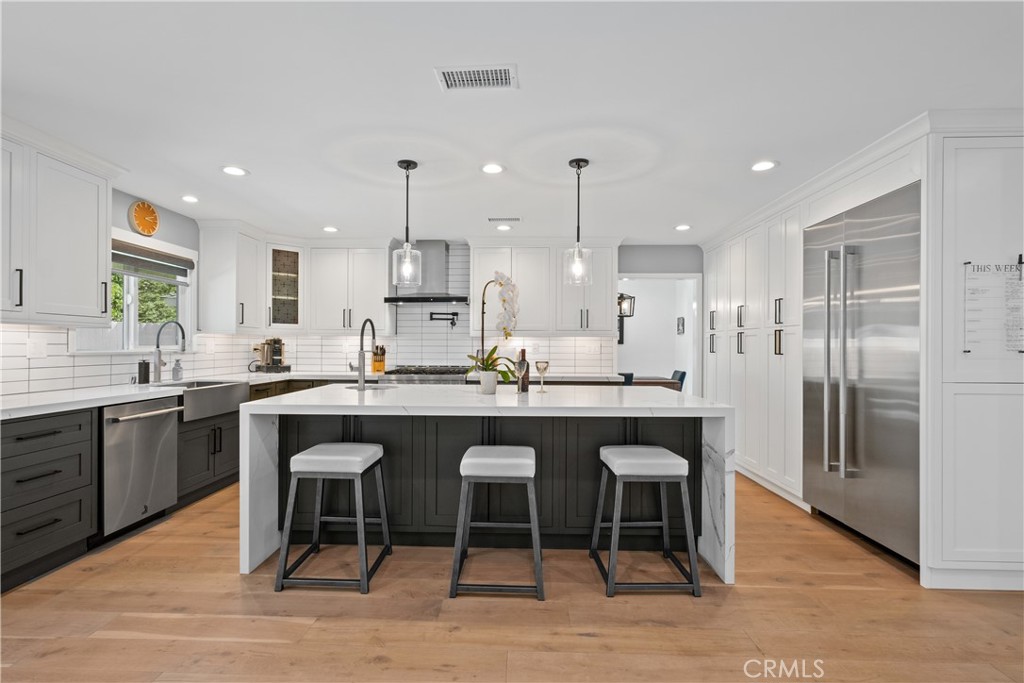 2744 Gannet Drive Costa Mesa, CA 92626 - Photo 6 of 39 a large kitchen with a table and chairs
