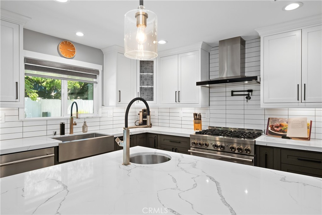 2744 Gannet Drive Costa Mesa, CA 92626 - Photo 8 of 39 a kitchen with stainless steel appliances a sink a stove and a wooden cabinets