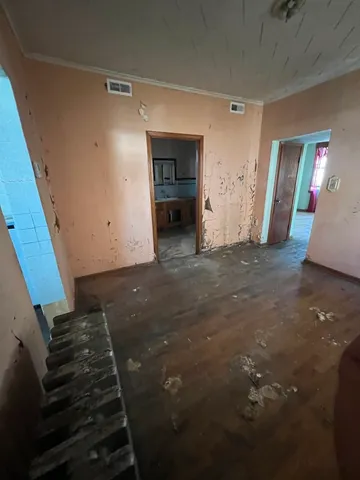 a view of a livingroom with an empty space and a fireplace
