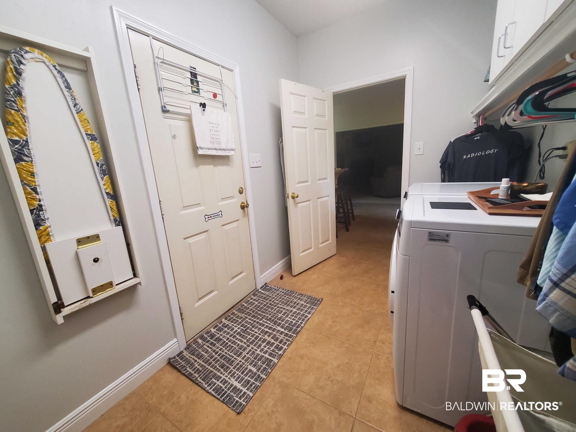 31163 Woodland Way Daphne, AL 36527 - Photo 25 of 44 Washroom featuring light tile patterned flooring, separate washer and dryer, and cabinets